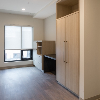 Unfurnished One Bedroom Suite - Living Room with built-in millwork cabinetry 